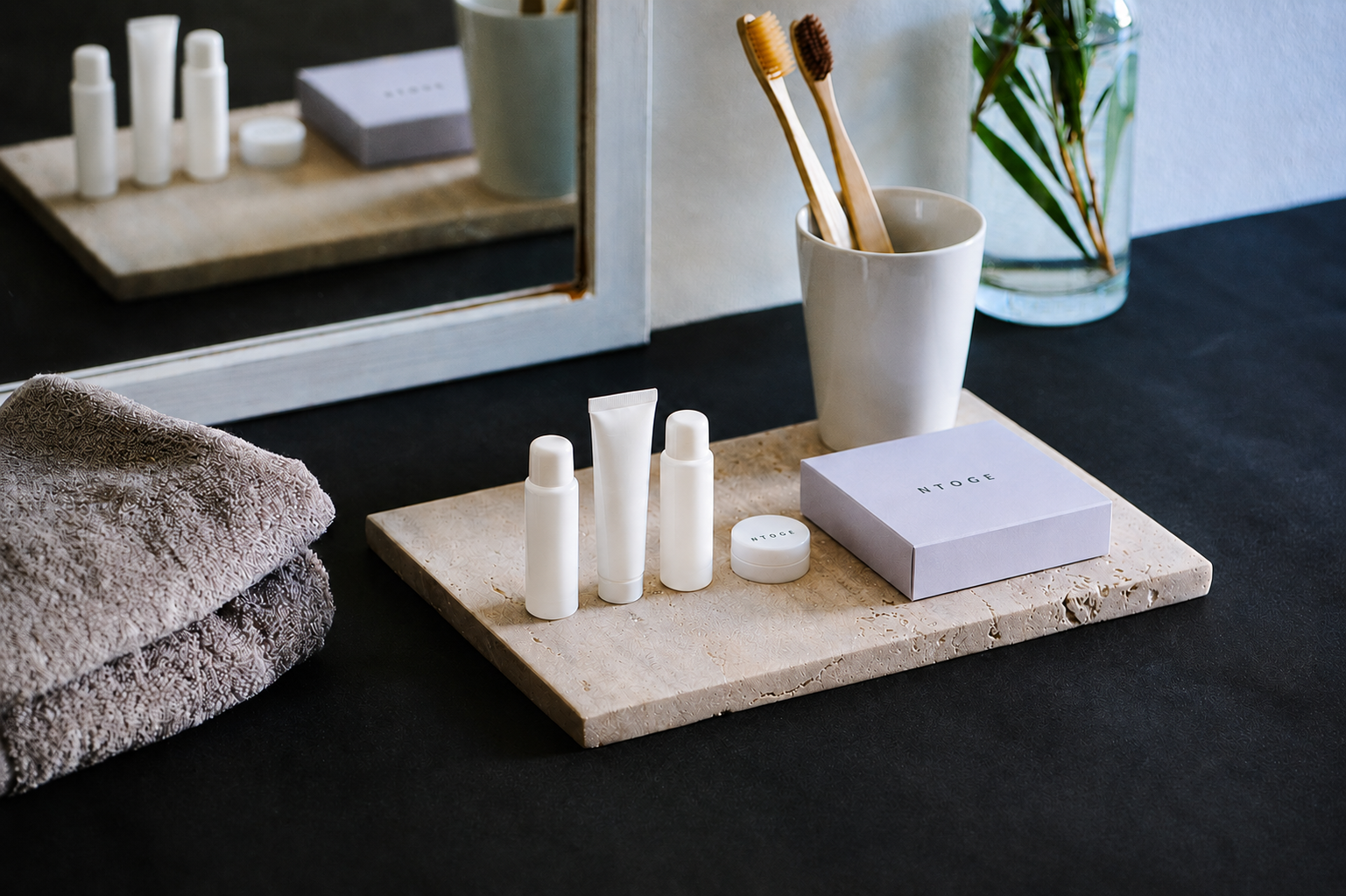 NTOGE hotel amenities arranged in a guest bathroom.